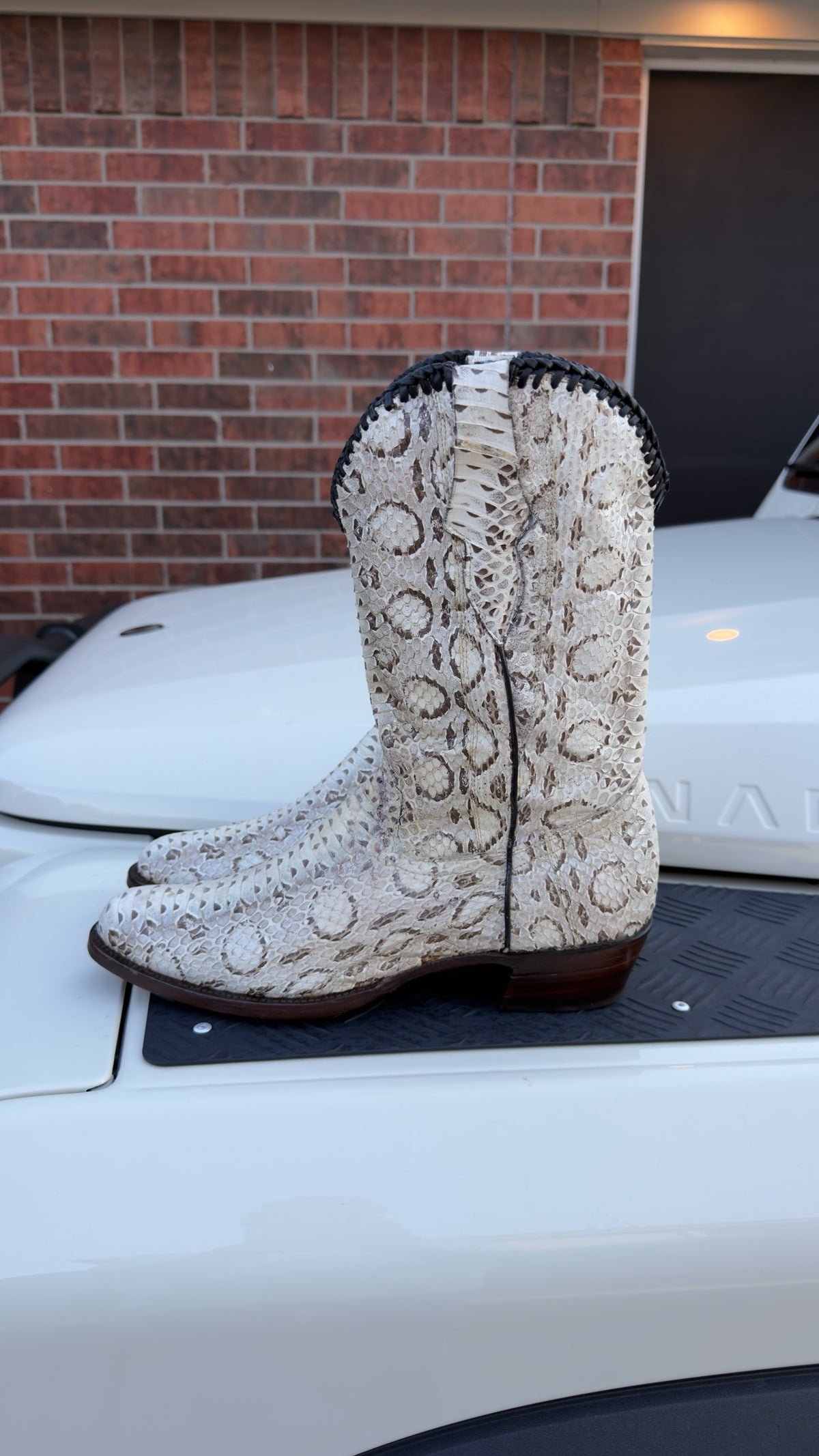 UNO Boots & Collectables genuine python skin cowboy boots in cream and earth tones with dark braided collar trim.