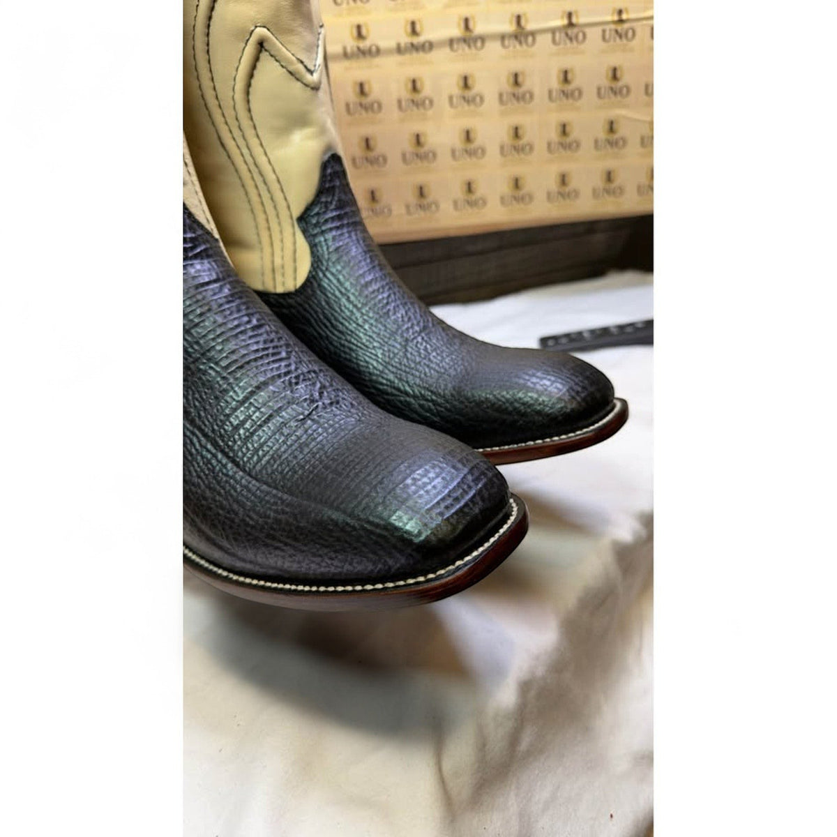 UNO Boots & Collectables two-tone cowboy boots with black textured vamp and cream leather shaft, square toe design.